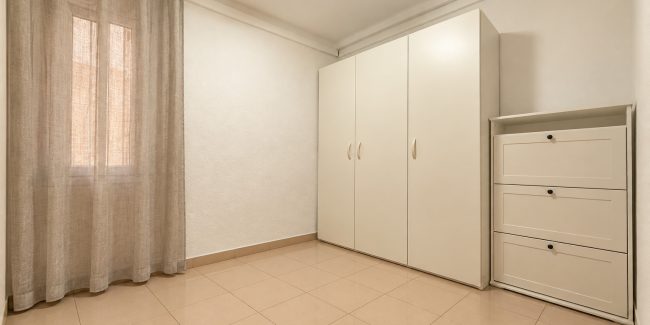 Habitación minimalista con armario y cortinas